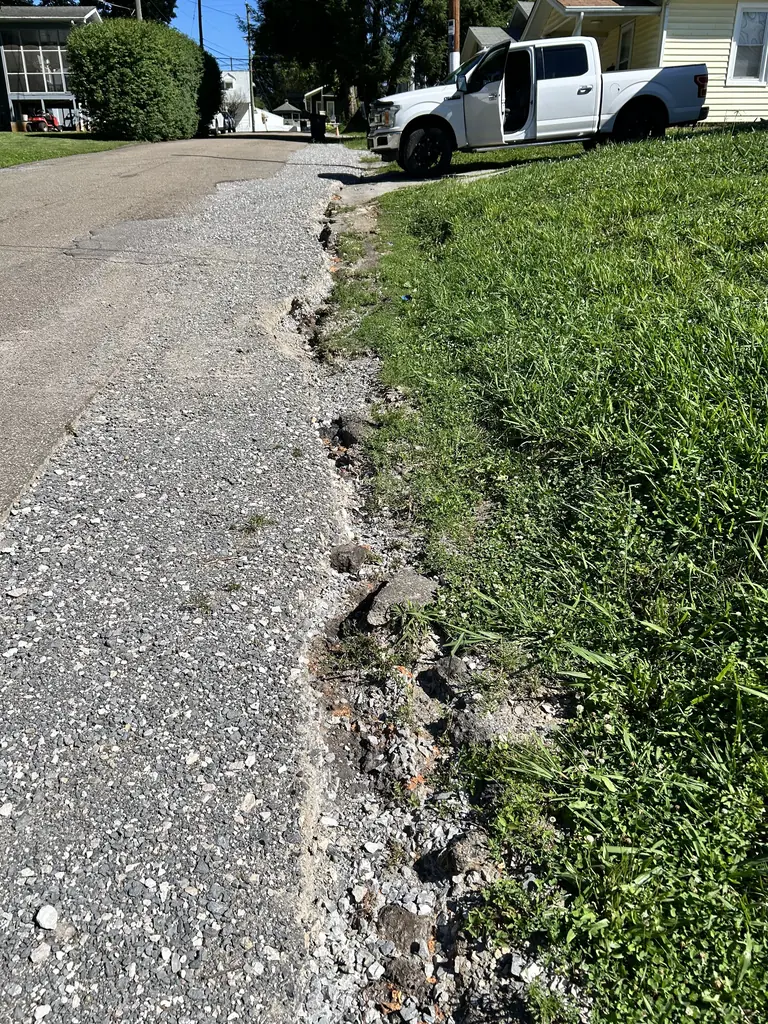 Shoulder erosion along a gravel driveway in Knoxville, Tennessee