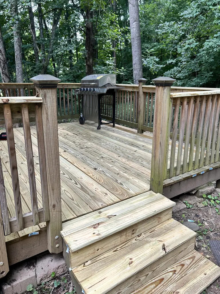 Backyard wood deck with steps down to the yard in Knoxville, Tennessee