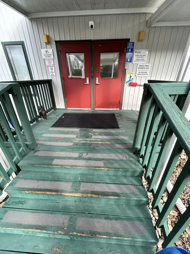 Covered walkway with railings leading to a building entrance in Knoxville, TN
