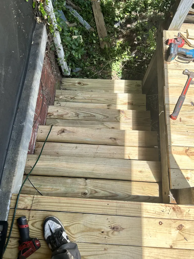 New pressure-treated stairs going in beside a house in Knoxville, Tennessee