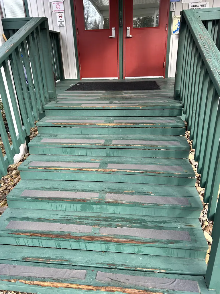 Painted stairs and railings up to a set of double doors in Knoxville, Tennessee