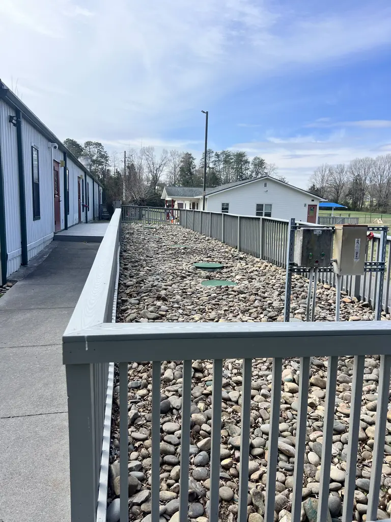 Railing along an elevated walkway over a gravel bed in Knoxville, Tennessee