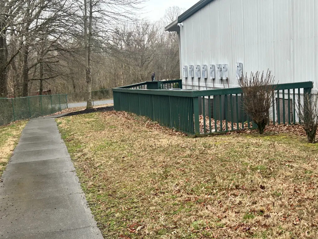 Railing running along a sloped yard beside a building in Knoxville, Tennessee