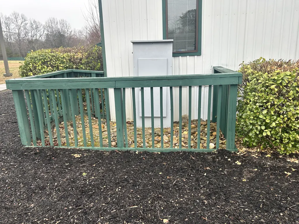 Railing enclosure and mulch bed behind a building in Knoxville, Tennessee