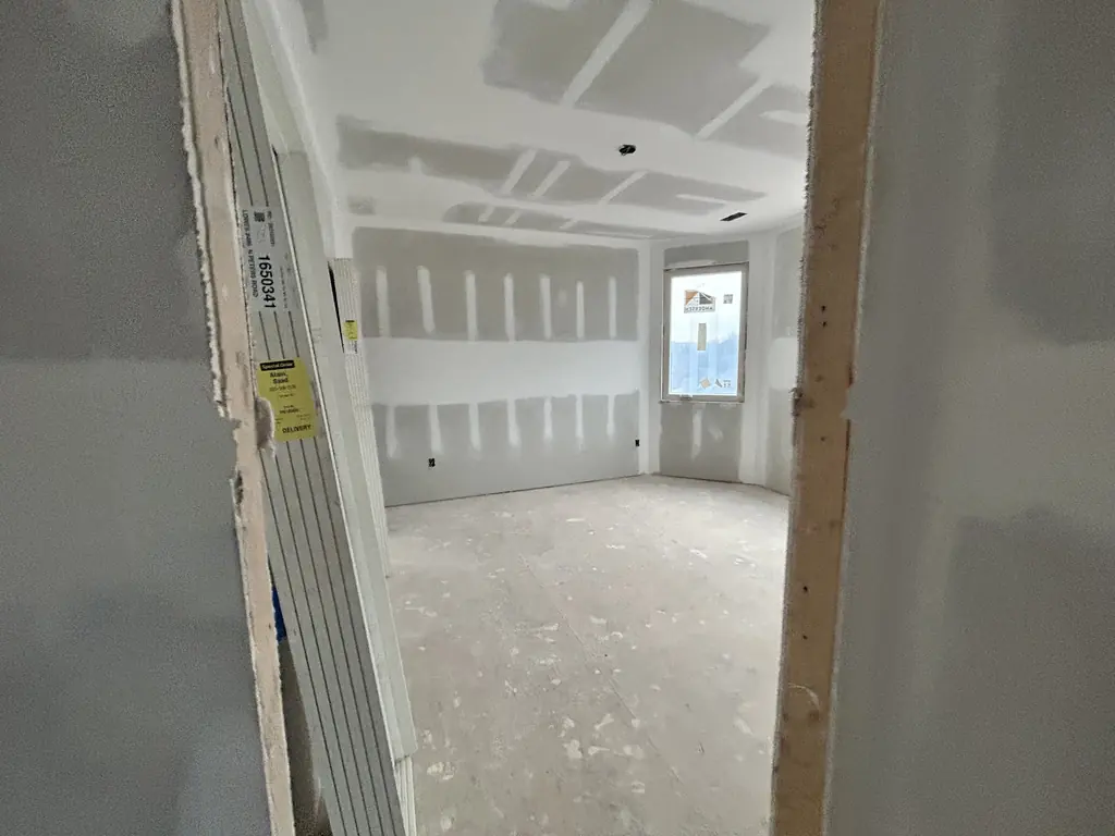 Finished drywall in a room with new windows in Knoxville, Tennessee