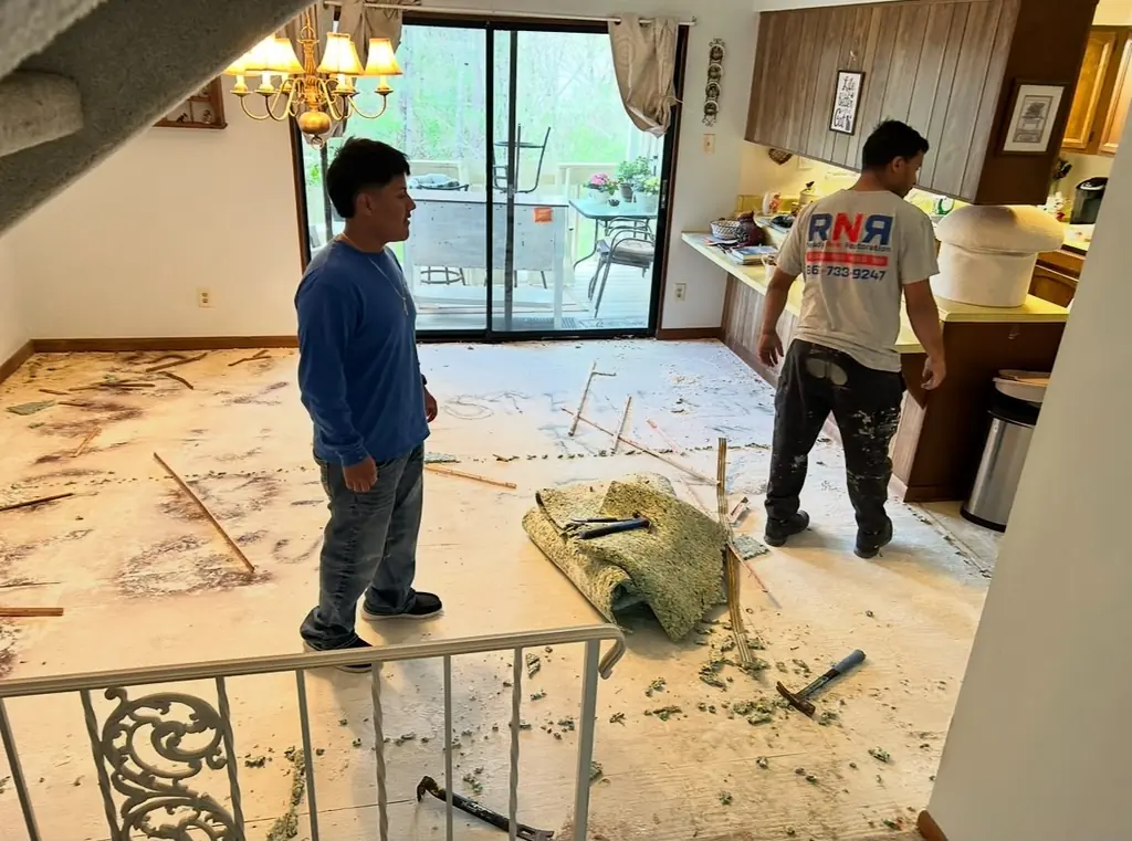 Crew pulling out the old carpet and pad in Knoxville, Tennessee