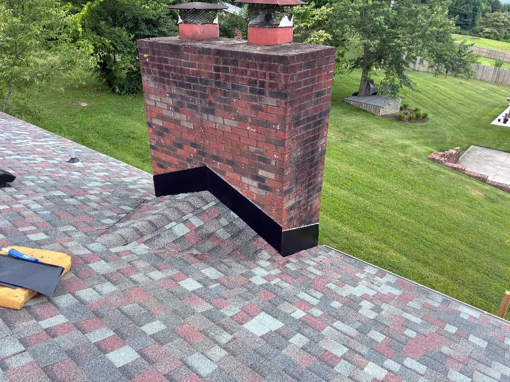Brick chimney flashed into a finished shingle roof in Knoxville, Tennessee