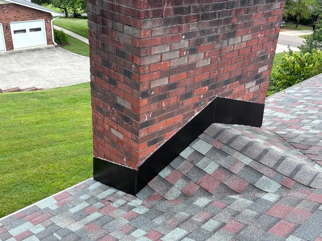 Chimney and ridge cap on a completed roof replacement in Knoxville, Tennessee