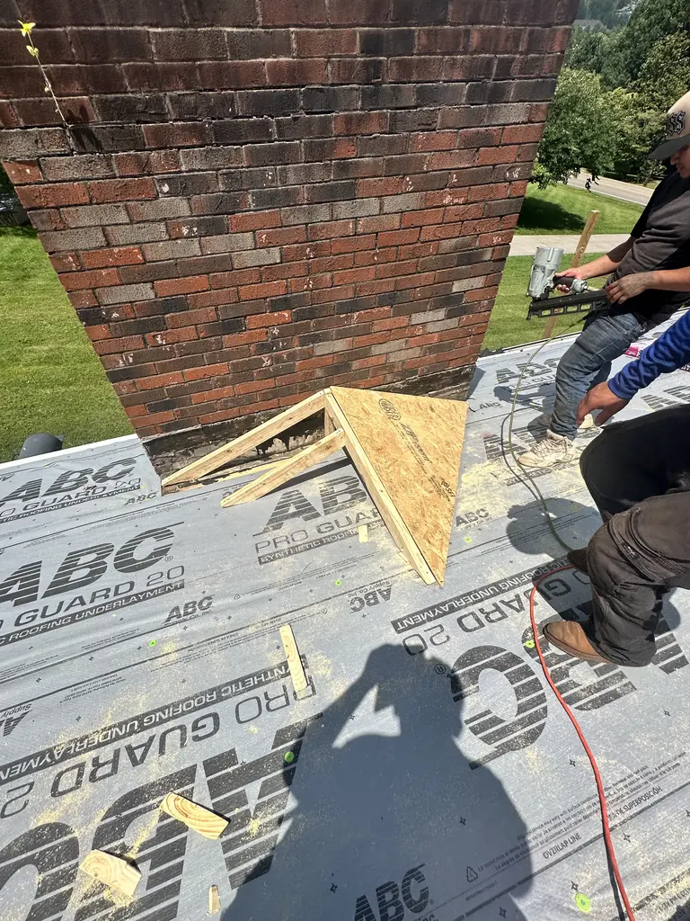 Chimney flashing and underlayment detail during a roof replacement in Knoxville, TN