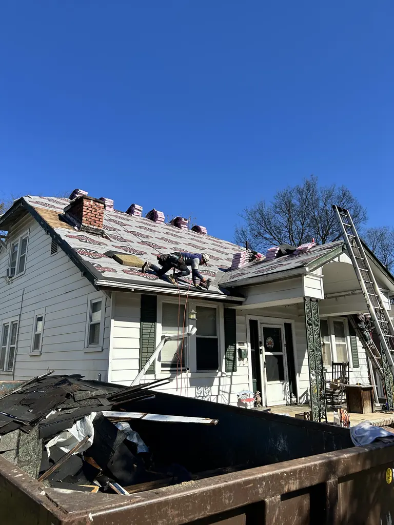 Crew stripping an old roof down to the deck in Knoxville, Tennessee