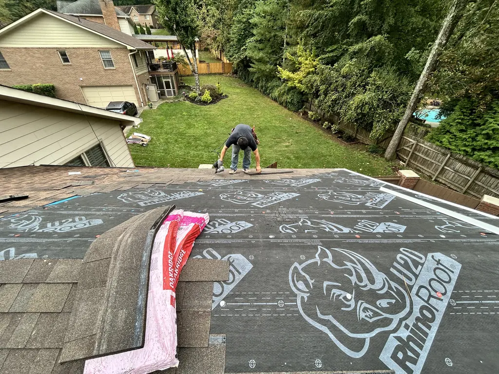 Underlayment and shingles going down on a roof in Knoxville, Tennessee