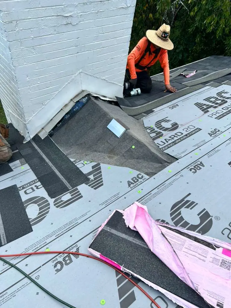 Synthetic underlayment and valley membrane going down around a chimney in Knoxville, Tennessee